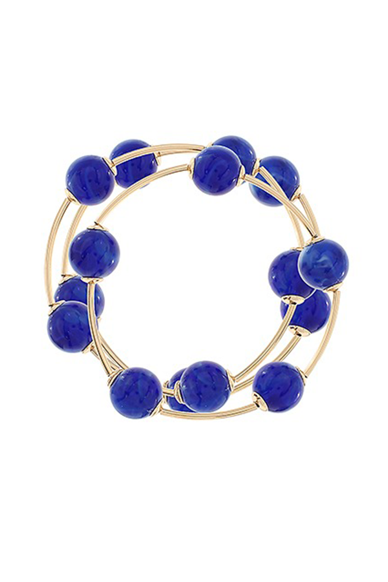 Gold bracelet with blue beads on a white background