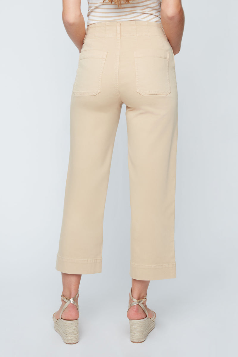 Beige pants worn by a person on a light gray background