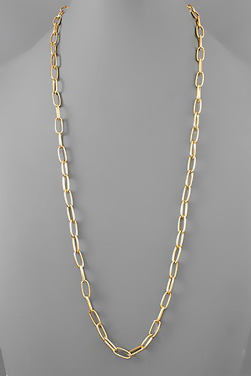 Gold chain necklace on a gray background