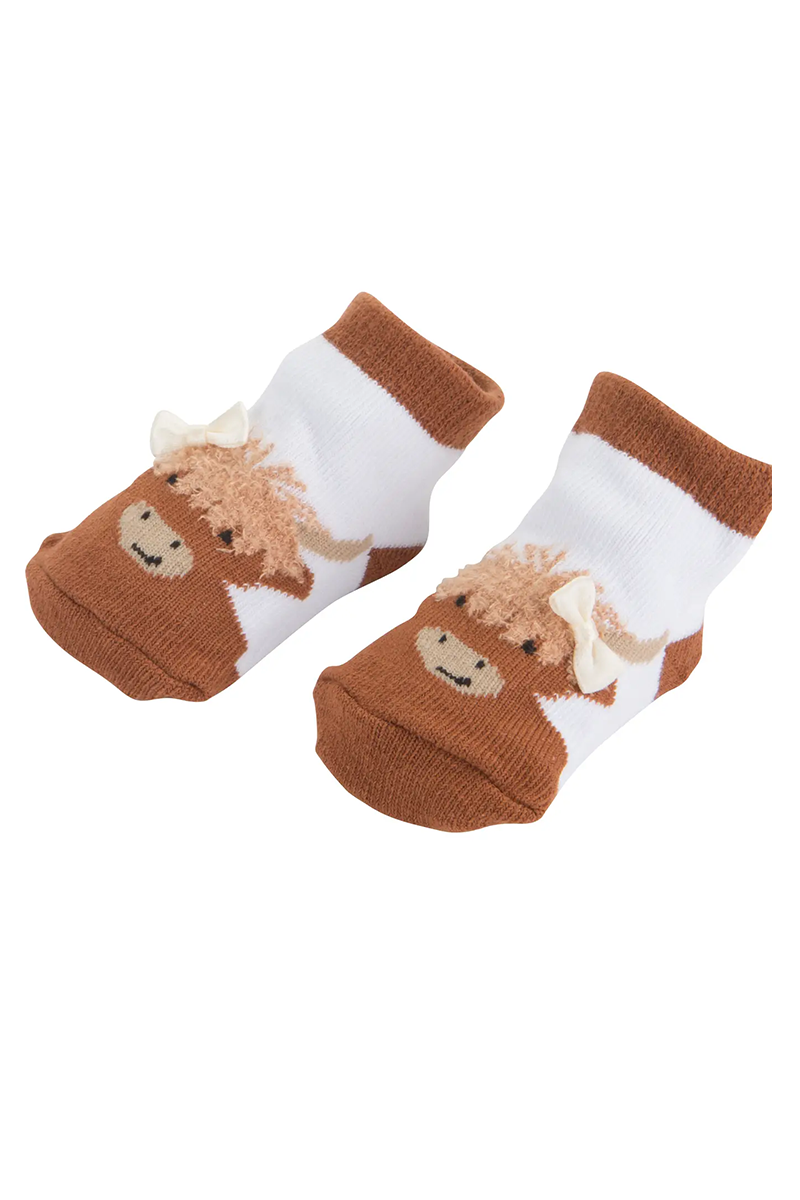 Pair of socks with highland cow illustration with a bow on a white background