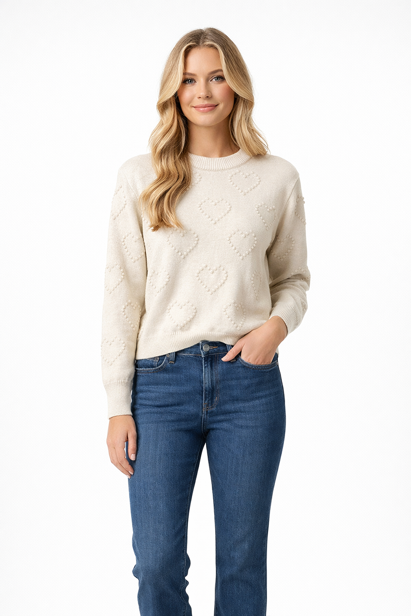 Woman wearing a cream sweater and blue jeans on a white background