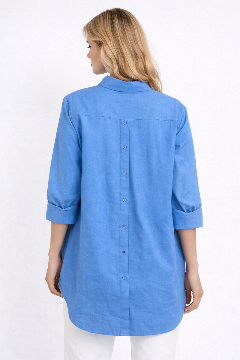 Back of a woman wearing a blue shirt on a white background