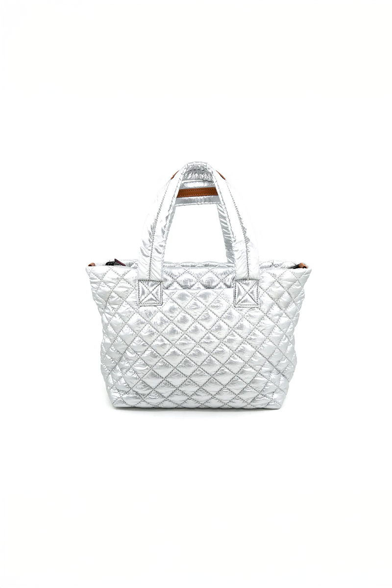Silver quilted handbag on a white background