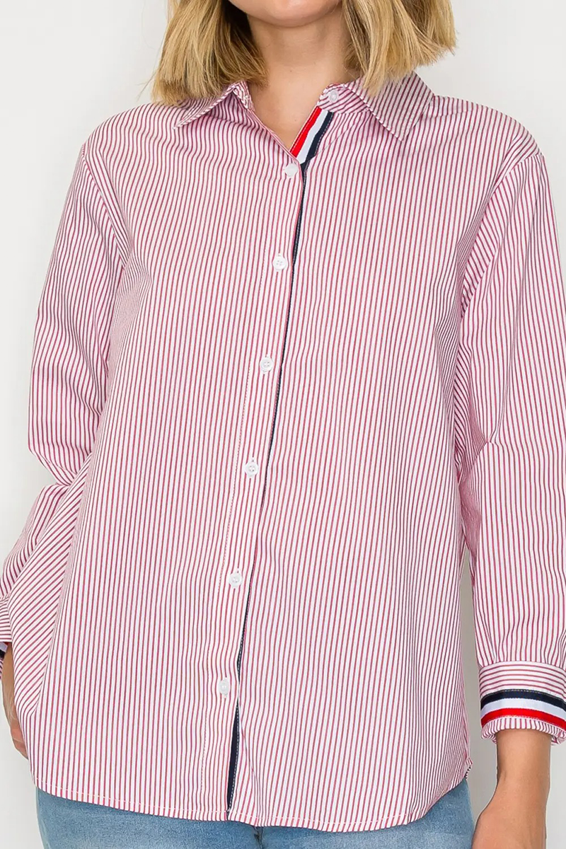 Person wearing a red and white striped shirt with a visible brand logo on a plain background