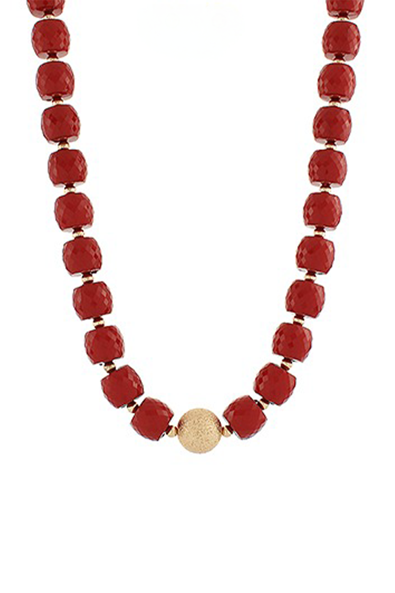 Necklace with red beads and a gold accent on a white background