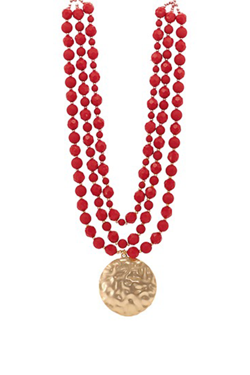 Red beaded necklace with a gold pendant on a white background