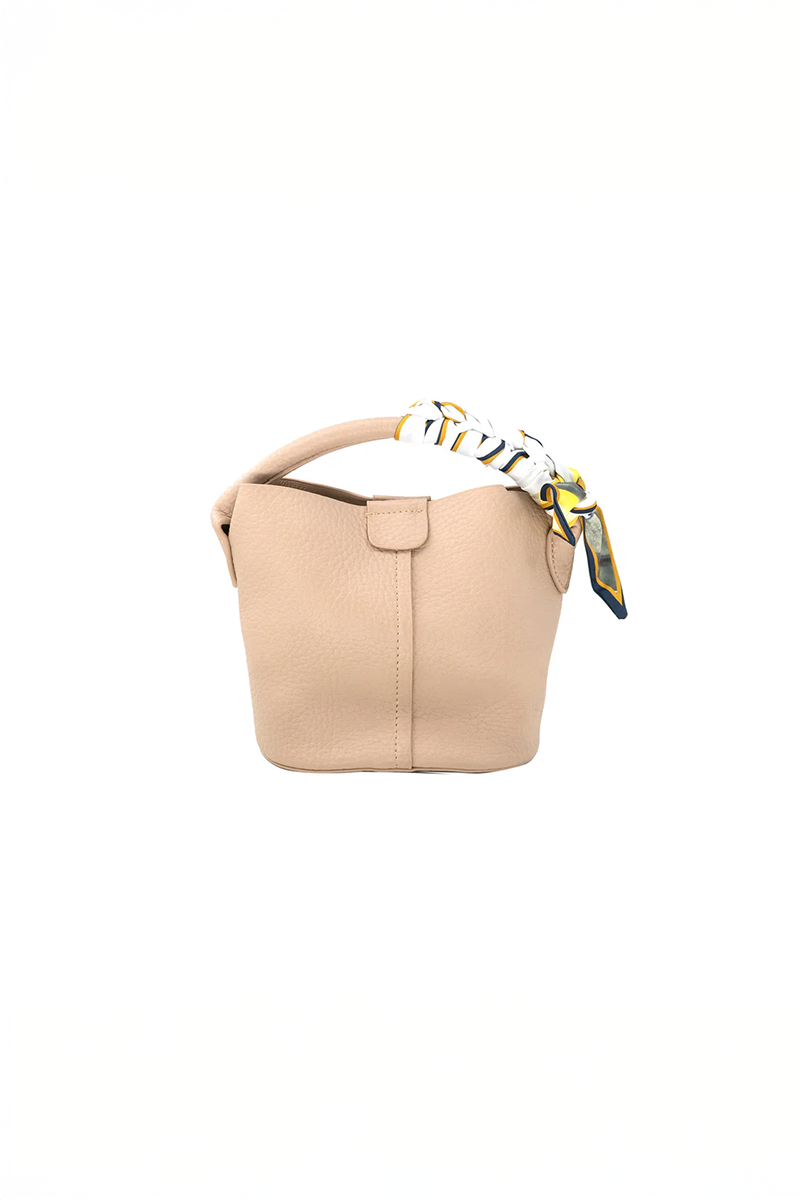 Beige handbag with a decorative strap on a white background
