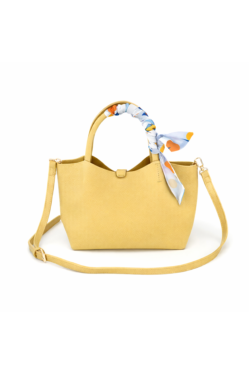 Yellow handbag with a colorful scarf on a white background