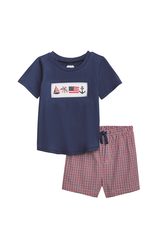 Navy t-shirt with graphic design and plaid shorts on a white background