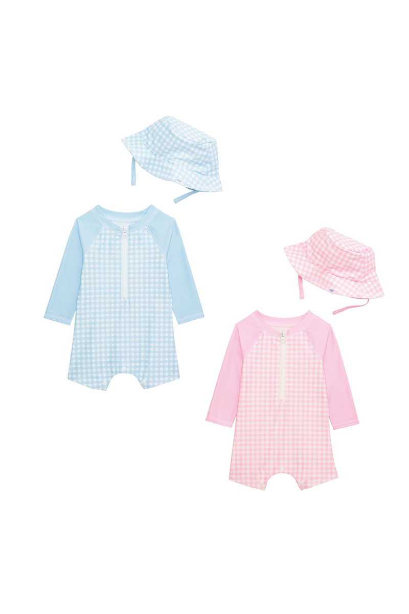 Two baby rashguard unisuits with matching hats on a white background