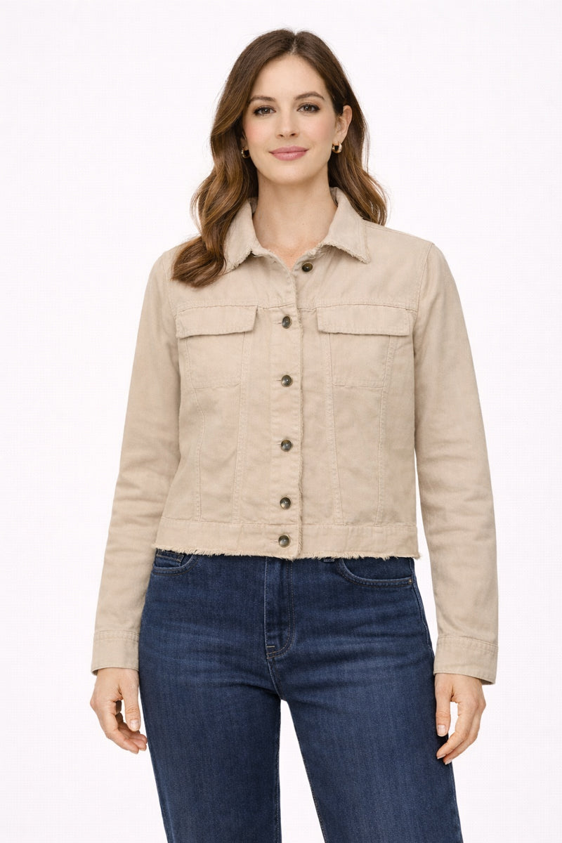 Woman wearing a beige jacket and blue jeans on a white background
