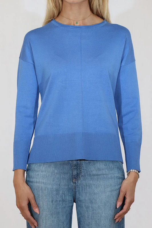 Person wearing a blue sweater and jeans on a white background