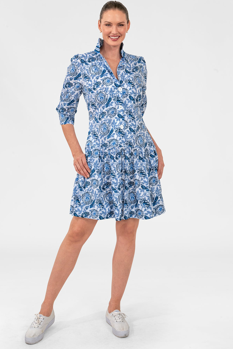 Woman wearing a blue floral dress on a white background