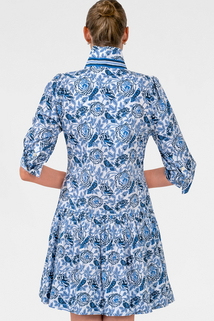 Woman wearing a blue patterned dress on a white background