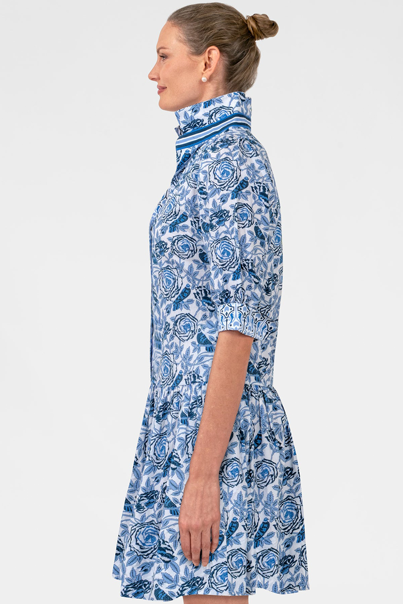Woman wearing a blue floral dress on a white background
