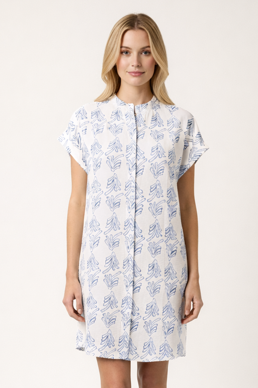 Woman wearing a white dress with blue floral pattern on a white background