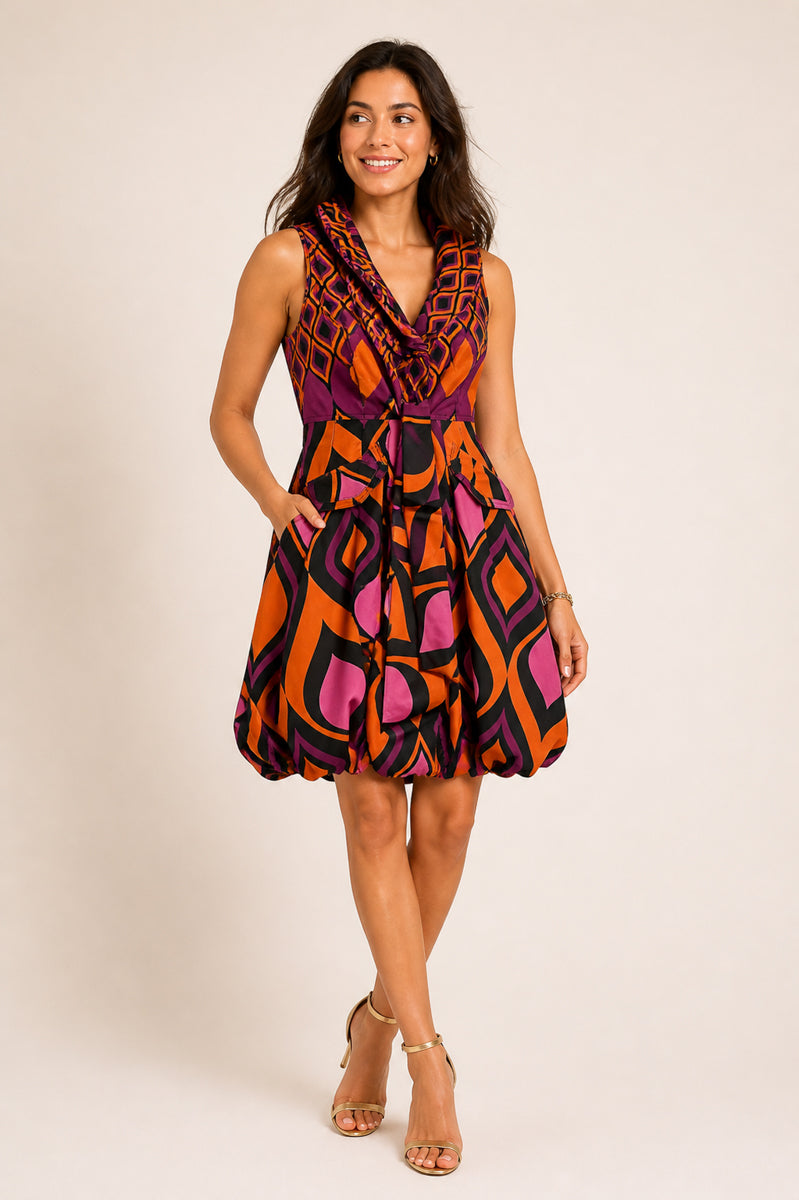 Woman wearing a colorful patterned dress on a beige background
