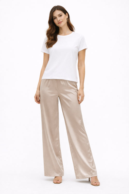 Woman wearing a white t-shirt and beige pants on a white background