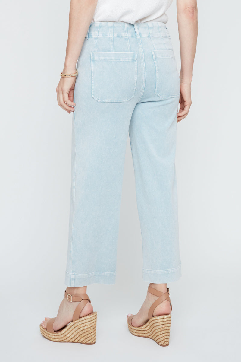 Light blue jeans worn by a person on a white background