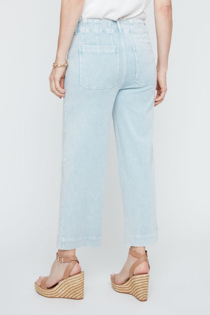Light blue jeans worn by a person on a white background