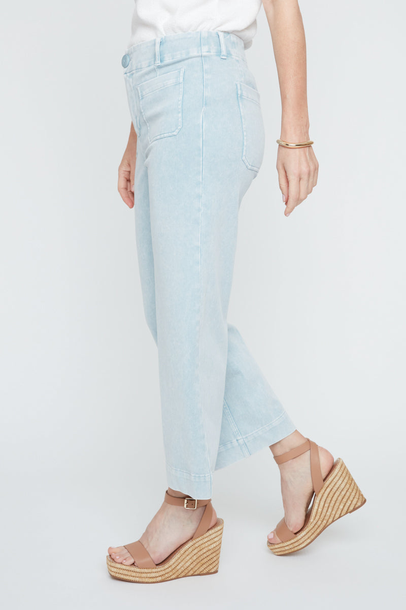 Light blue jeans worn by a person on a white background