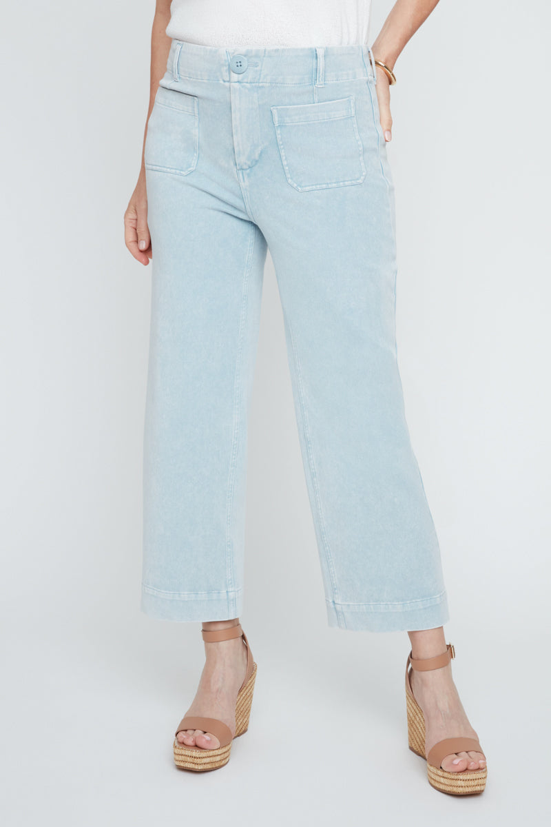 Light blue jeans worn by a person on a white background