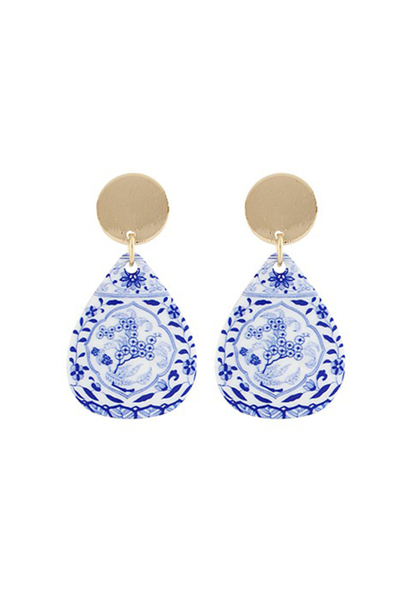 Pair of blue and white teardrop earrings with gold accents on a white background