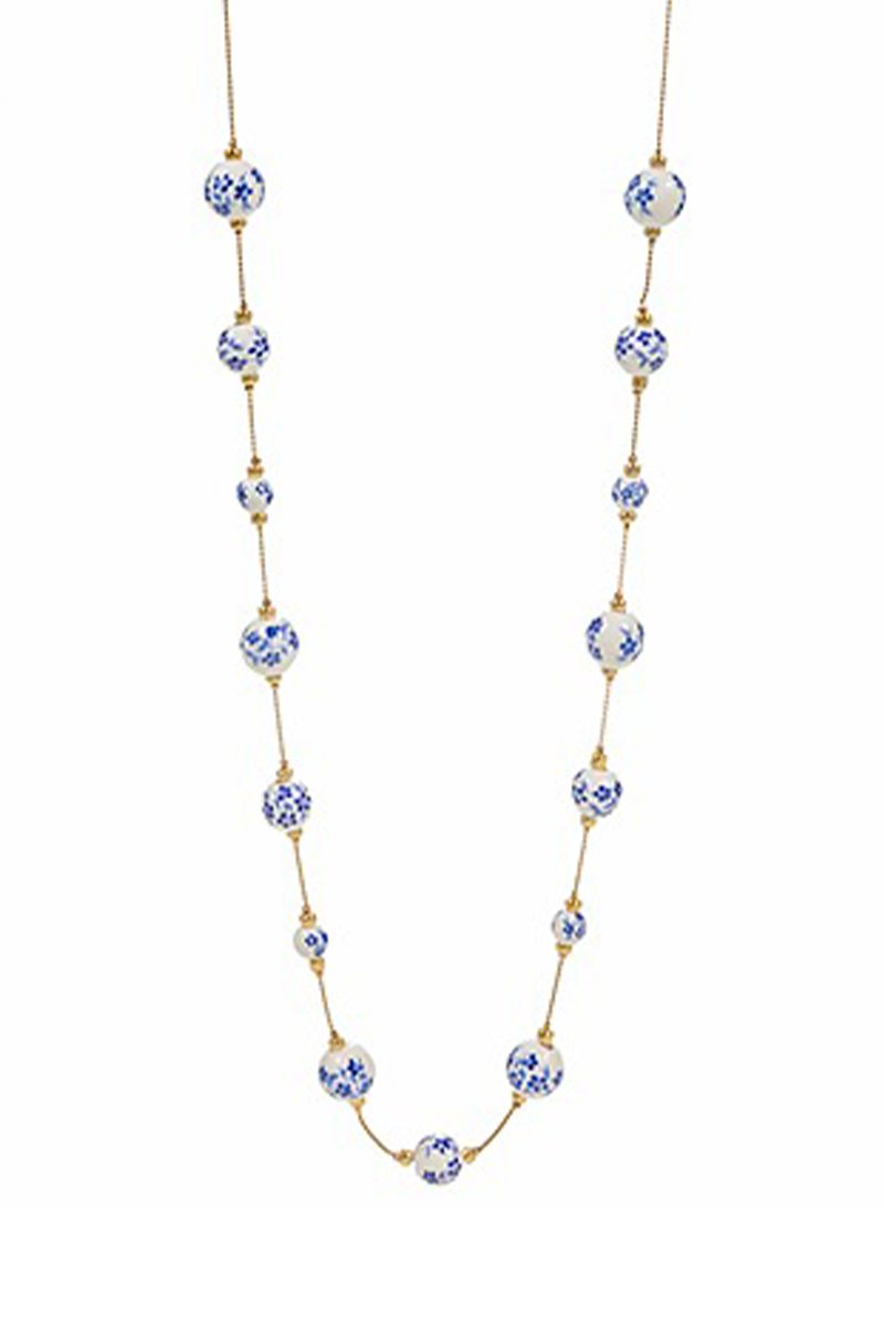Necklace with blue and white ceramic beads on a white background