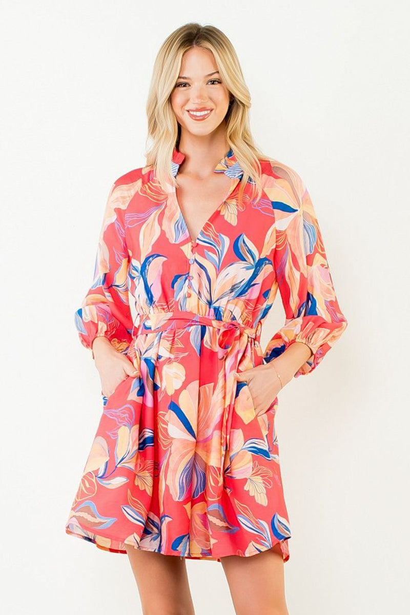 Woman wearing a colorful floral dress on a white background