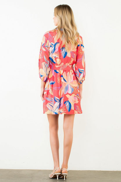 Woman wearing a colorful dress with a white background