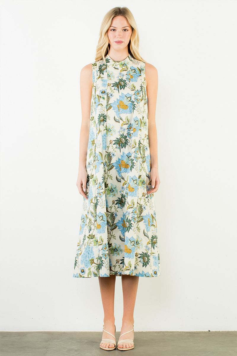 Woman wearing a floral sleeveless dress on a white background