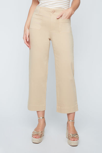 Person wearing beige pants and sandals on a white background