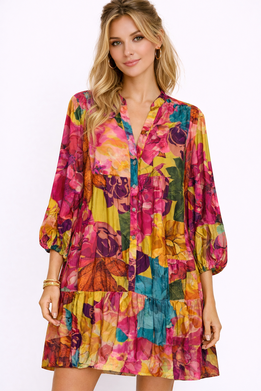 Woman wearing a colorful floral dress on a white background