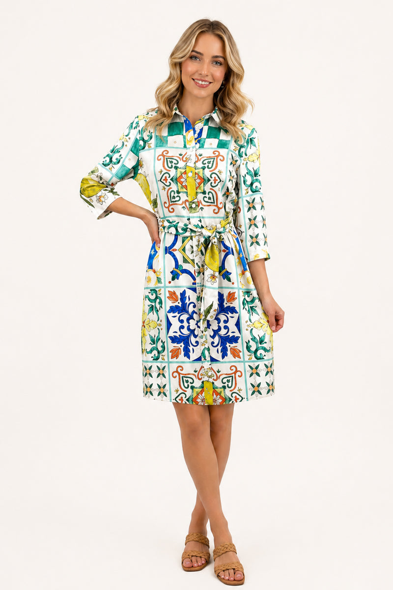 Blonde woman wearing Florence Tile Belted Dress on a white background