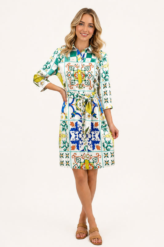 Blonde woman wearing Florence Tile Belted Dress on a white background