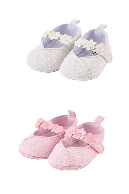 Pair of baby girl shoes with floral details on a white background