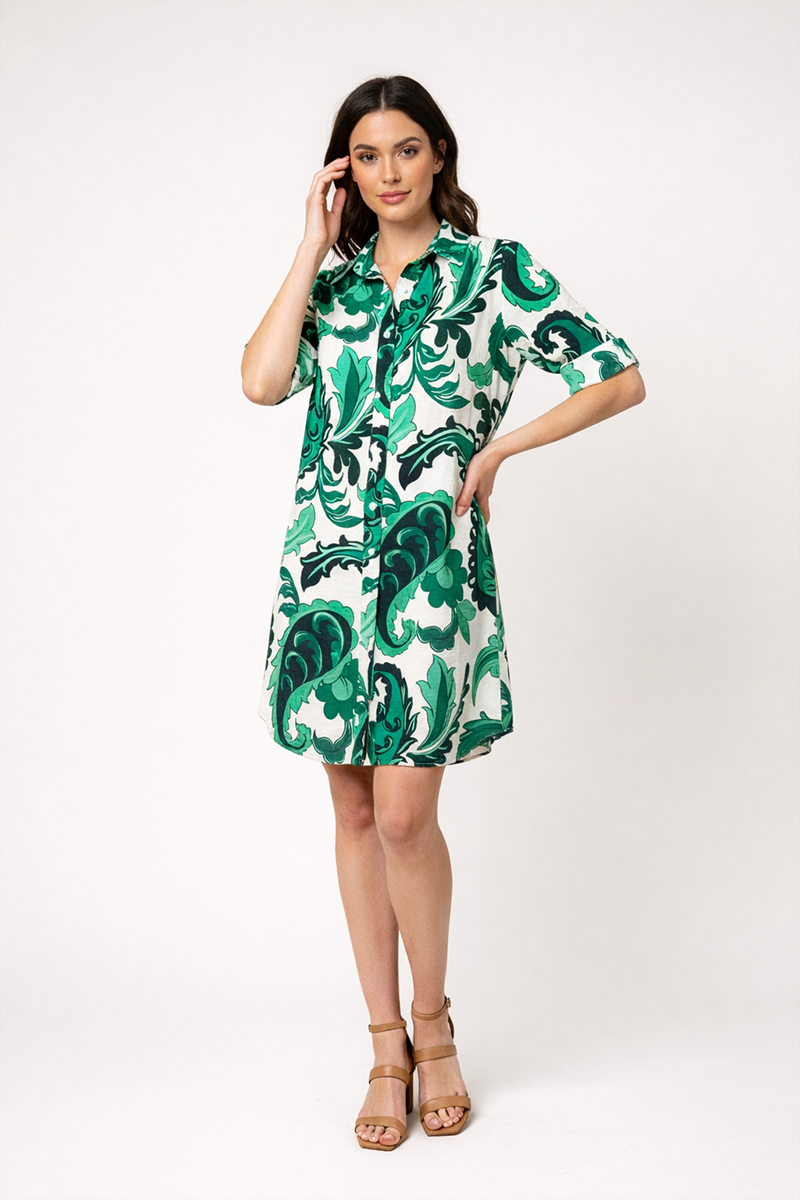 Woman wearing a green and white patterned dress on a white background