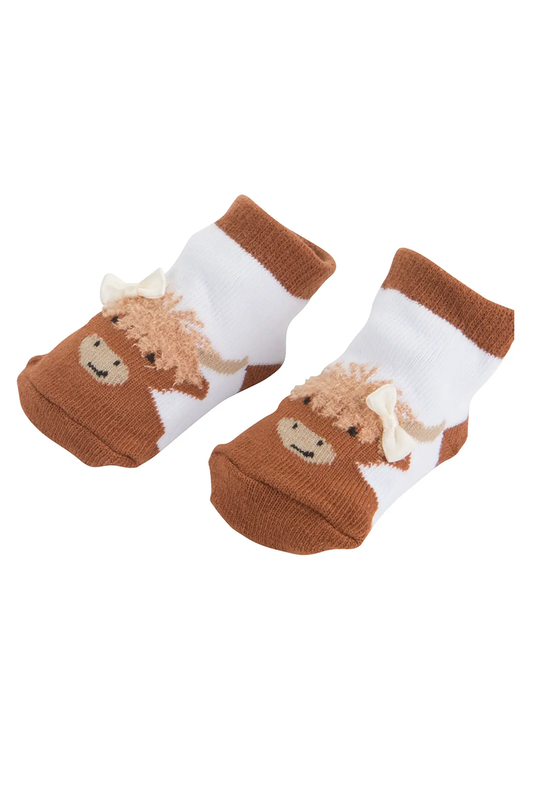 Pair of socks with highland cow illustration with a bow on a white background