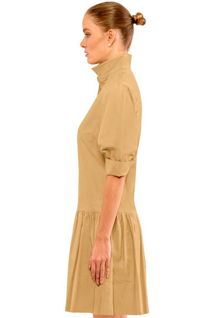 Woman wearing a beige dress on a white background