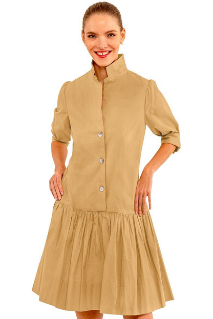 Woman wearing a beige dress with a white background