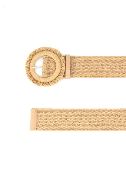 Beige belt with a round buckle on a white background