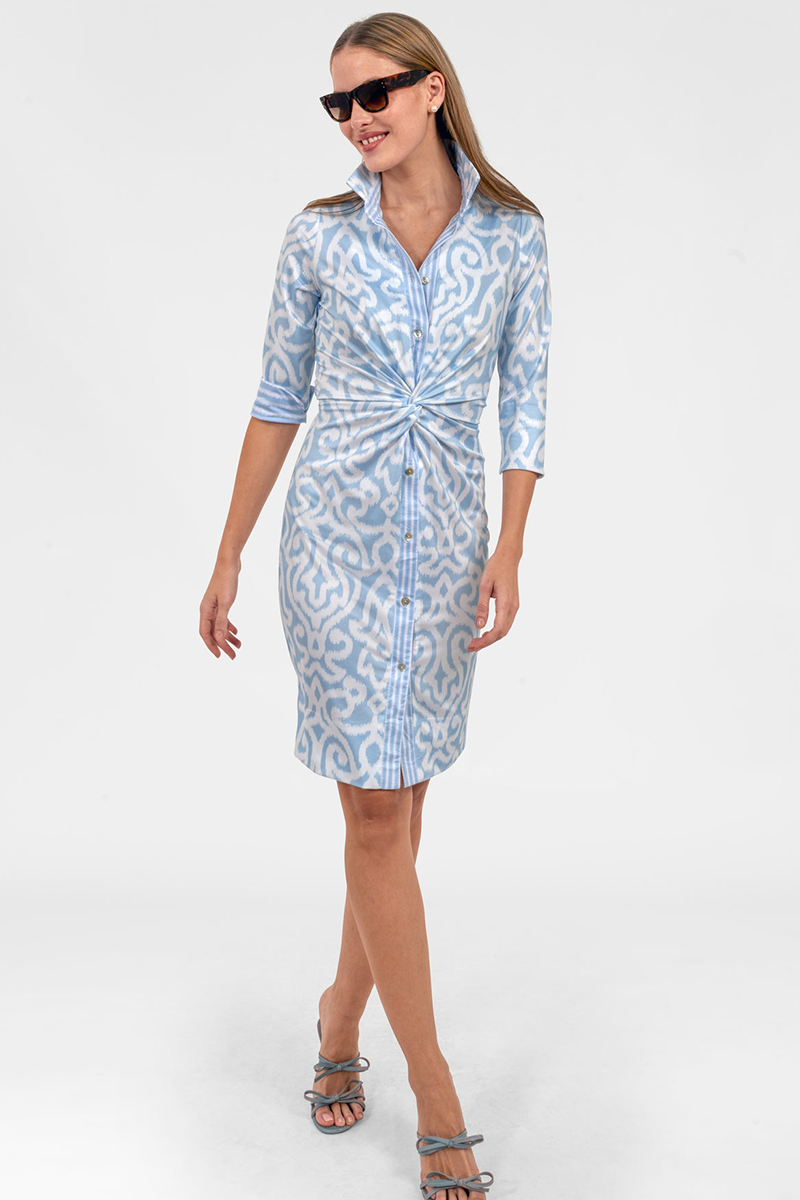 Woman wearing a light blue patterned dress on a white background