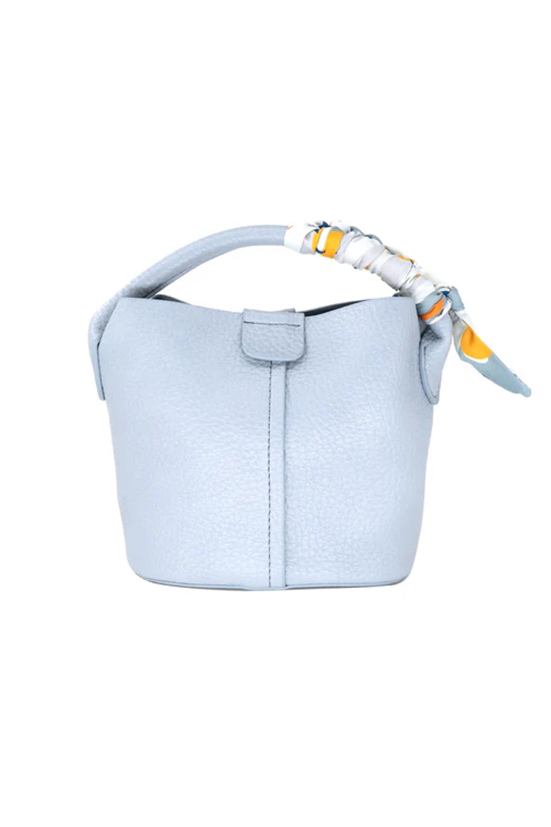 Light blue handbag with a strap on a white background