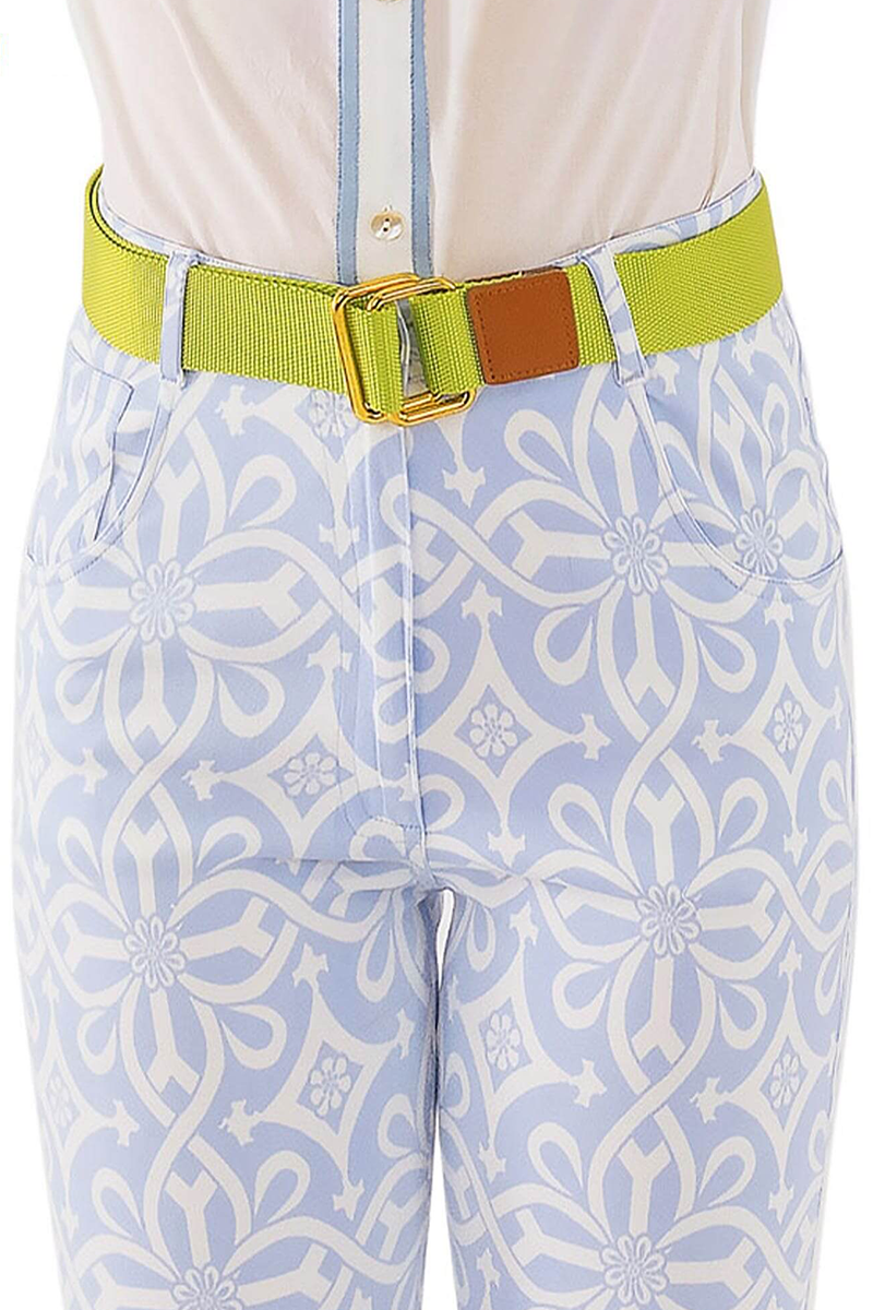 Light blue patterned pants with a green belt and white shirt.