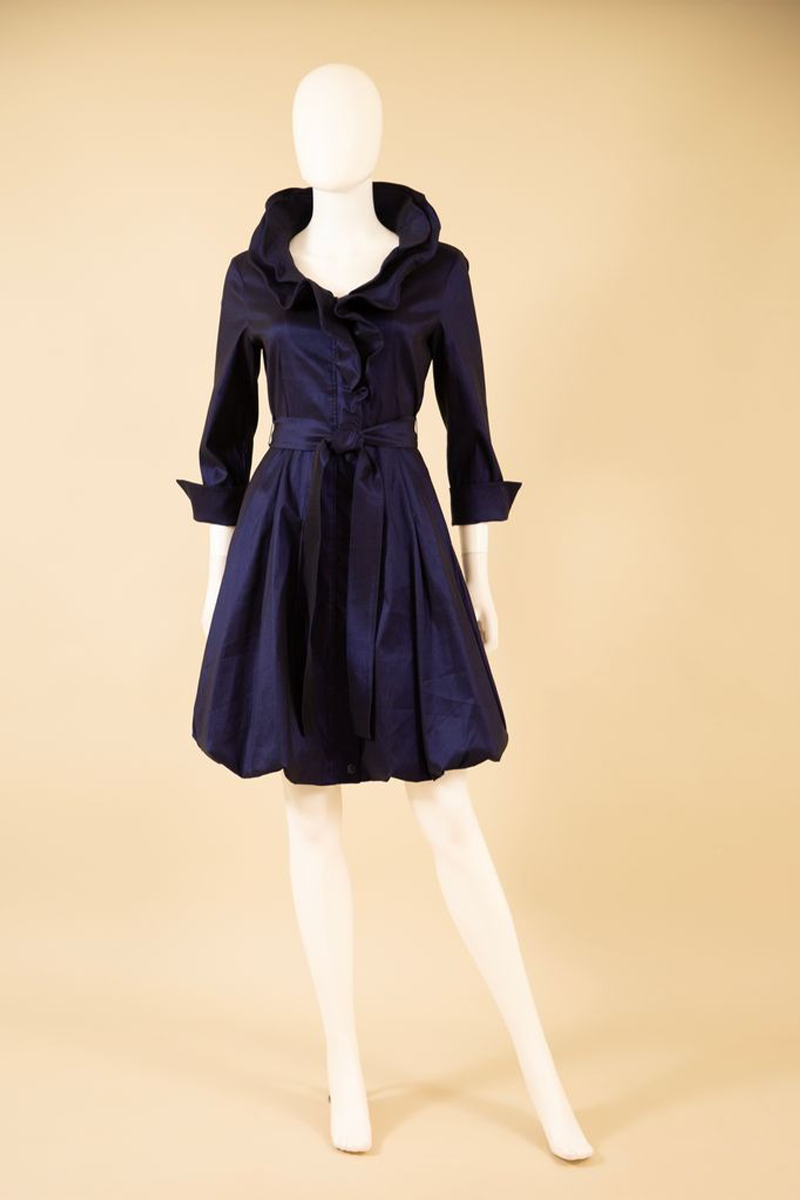 Navy blue dress on a mannequin against a beige background