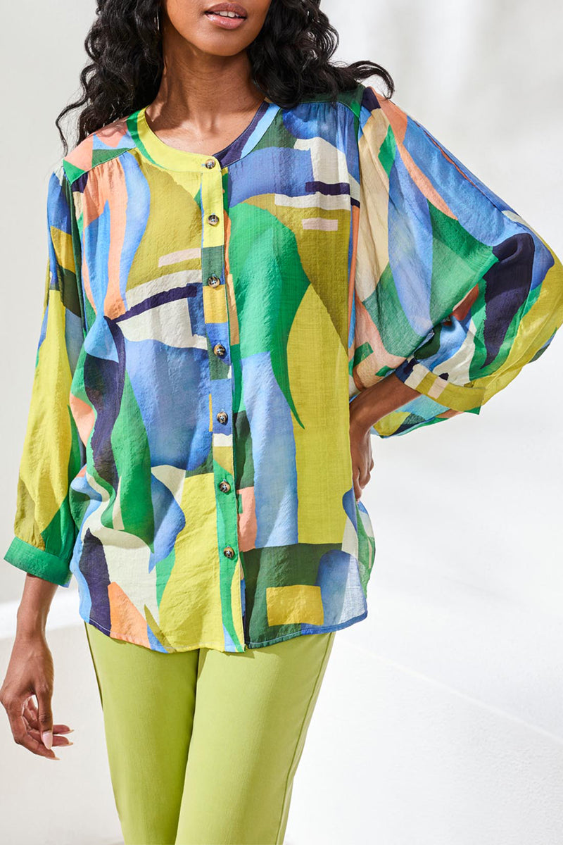 Woman wearing a colorful abstract patterned top with a white background