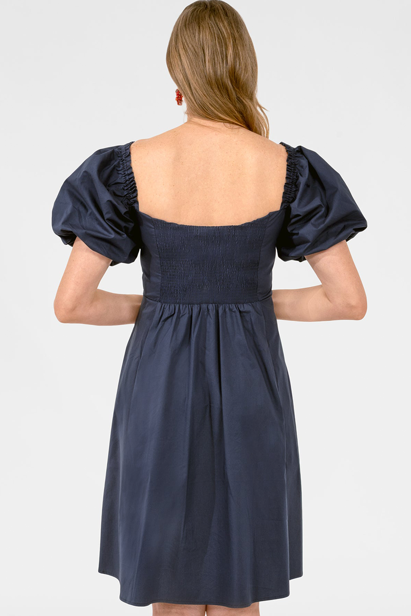 Navy blue dress with puff sleeves on a white background