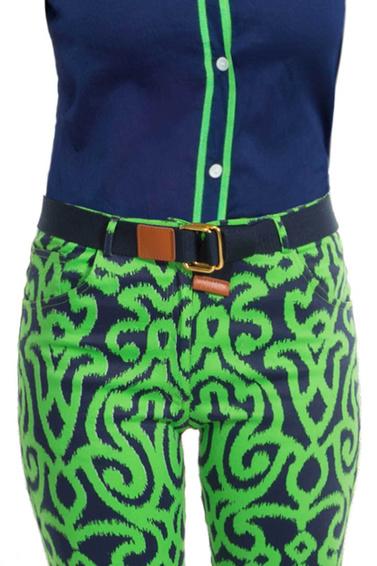 Green and blue patterned pants with a navy belt on a white background