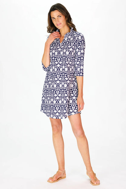Woman wearing a blue floral dress on a white background