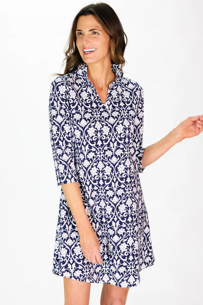 Woman wearing a blue and white patterned dress on a white background